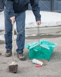 a man sweeping the street with a broom