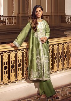 2 Piece - Embroidered Suit Make a bold statement with this 2-piece green dress, crafted from a combination of silk cotton net and viscose raw silk, with intricate embroidery for added texture and style. The full-sleeved jacket features a crew neckline, plain back, and embroidered border, while the trousers feature a boot cut design. Perfect for any occasion, this dress will be sure to turn heads. 2-Piece Front Open Jacket with TrousersMake a fashionable statement in green front open jacket featu Spring Designer Wear Cotton Silk Dress, Spring Festive Chanderi Embroidered Dress, Pista Green Silk Kurta For Spring, Elegant Cotton Silk Dresses With Dabka, Elegant Cotton Silk Embroidered Dress, Spring Chanderi Dress, Spring Designer Chanderi Dress, Festive Spring Dresses In Cotton Silk, Traditional Chanderi Dresses For Spring