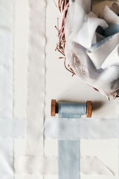 a close up of a piece of cloth with some scissors and thread on top of it