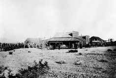 an old black and white photo of people in the desert