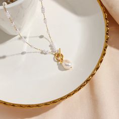 Elevate your look with the Pearl Drop Gold Necklace. The delicate pearl beads add a touch of elegance and sophistication to any outfit. Make a statement and exude confidence with this timeless piece. DETAILS & SIZE Finish: 18K gold plate Materials: Stainless Steel; Synthetic Pearl; Freshwater Pearl (pendant) Measurements: Pendant: 11x7.5mm; Chain: 21" Toggle pendant clasp Waterproof, tarnish-resistant, and nickel free Shop the Pearl Passion collection! Or shop our Necklaces for more options to layer this with! Pearl White Pearl Clavicle Chain Necklace, Elegant White Chain Necklace With Pearl Drop, Gold Pearl Necklace With Baroque Pearls, Elegant Pearl Necklace With Beaded Chain As Gift, White Gold-plated Pearl Necklace With Pearl Charm, White Gold Plated Pearl Necklace With Charm, Gold Pearl Beaded Necklace With Pearl Charm, Pearl White Pearl Chain Necklace In Gold Plated, Gold Pearl Necklace With Beaded Chain