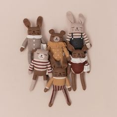 a group of stuffed animals in sweaters and mittens