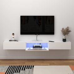 a flat screen tv sitting on top of a white entertainment center