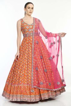 Orange anarkali with floral motif embroidery highlighted with mirror work. Comes with mirror work dupatta.
Components:2
Pattern:Embroidered
Type of Work:Mirror Work
Neckline:V-Neck
Sleeve Length:Sleeveless
Fabric:Crepe, Modal Satin, Butterfly Net
Color:Orange
Other Details:
Beaded neckline
Floral motifs
Occasion:Bride,Wedding - Aza Fashions Floor-length Dori Work Salwar Kameez For Navratri, Designer Orange Lehenga With Mirror Work, Designer Wear Orange Lehenga With Mirror Work, Navratri Gown In Chinon With Dori Work, Navratri Chinon Gown With Dori Work, Chinon Gown With Dori Work For Navratri, Traditional Chinon Gown With Mirror Work, Orange Chanderi Dupatta With Mirror Work, Designer Orange Dupatta With Mirror Work