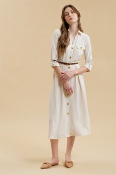 Get ready to stand out in the Monica Midi Dress, featuring a collared neckline and button down front. With gold buttons and hardware, this dress comes complete with a belted waist and pintuck details for a flattering silhouette. The long sleeves with cuff and tab detail, along with the midi length, make this a versatile shirt dress for any occasion. Plus, it even has pockets for added convenience! Semi-formal Belted Shirt Dress For Fall, Belted Shirt Dress For Semi-formal Fall Occasions, Fall Collared Belted Dress With Belted Cuffs, Collared Belted Dress For Work In Fall, Fall Collared Belted Dress For Work, Chic Button-up Belted Dress For Fall, Chic Fall Belted Button-up Dress, Elegant Workwear Dresses With Gold Buttons, Fitted Collared Belted Dress With Buttons