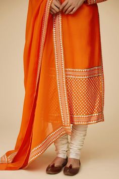 Tangerine orange long sleeves A-line kurta in chanderi base with round neckline and floral tonal jaal sequin embroidery. Paired with ivory churidar and floral aari work with sequin highlights viscose organza dupatta.
Components: 3
Pattern: Embroidery
Type Of Work: Aari Work With Sequins and Zari
Neckline: Round
Sleeve Type: Long
Fabric: Kurta: Chanderi, Dupatta: Viscose Organza, Churidar: Cotton
Color: Orange
Other Details: 
Length:
Kurta: 46inches
Churidar: 58inches
Dupatta: 2.5metres
Occasion: Chanderi Dupatta, A Line Kurta, Sequin Embroidery, Tangerine Orange, Pattern Embroidery, Organza Dupatta, Aari Work, Sequins Embroidery, Churidar