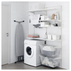 a white washer sitting next to a dryer in a laundry room on top of a shelf