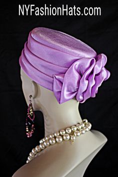 Women's Soft Lavender Purple Satin Couture Formal Pillbox Cocktail Wedding Church Hat. This Classic Styled Dressy Pillbox Holiday Hat Is Embellished With A Satin Bow Enhanced With A Rhinestone. This Bridal Mother Of The Bride Headpiece Can Be Worn With Embellishments Toward The Face Or To The Back Of The Head. This Elegant Satin Pillbox Hat Is Custom Made And Designed By NY Fashion Hats Couture Millinery. https://www.nyfashionhats.com. This New Collection Headpiece Is Part Of The Anastasia Konstandina Couture Headdress Line. This ladies bespoke pillbox hat is appropriate to wear for horse races, The Kentucky Derby, The Dubai World Cup, The Royal Ascot, The Melbourne Cup, Belmont Stakes, The Preakness Stakes horse racing, Church, weddings, and special occasion. This hat is also suited for m Mother Of The Bride Hats, Formal Hat, Bespoke Hats, Preakness Stakes, Royal Ascot Hats, Veiled Hats, Horse Races, Belmont Stakes, Church Weddings