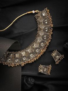 This jewellery set consists of a necklace and a pair of earrings Oxidized gold-plated handcrafted necklace, has white kundan-studded and gold-toned beaded detail Secured with a drawstring closure A pair of matching earrings, each secured with post and back closure Size & Fit Necklace: 19 cm x 4 cm Earrings: 3.5 cm x 2 cm Material & Care Material: Alloy Plating: Gold-plated Stone type: Kundan and artificial beads Dispatch within 7 days Gold Oxidised Jewellery, Golden Oxidised Jewellery, Dual-tone Gold Jewelry For Diwali, Gold Dual-tone Bridal Necklace For Festive Occasions, Festive Dual-tone Gold Bridal Necklace, Bollywood Style Dual-tone Gold Jewelry Sets, Gold Dual-tone Temple Jewelry Sets, Dual-tone Gold Temple Jewelry, Gold Dual-tone Jewelry Sets As Gift