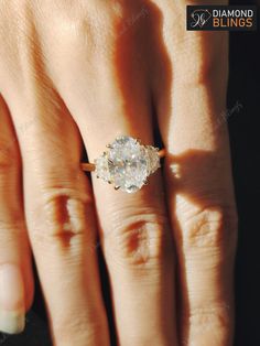 a woman's hand with a diamond ring on it