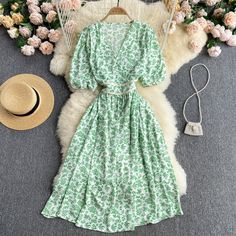 Brand Name: CroysierSilhouette: A-LINEOrigin: CN(Origin)Season: SummerNeckline: V-NeckSleeve Style: Puff SleeveDecoration: BeltStyle: CasualDresses Length: Mid-CalfMaterial: PolyesterAge: Ages 18-35 Years OldProfile Type: XModel Number: DW3705Closure Type: PulloverSleeve Length(cm): ShortType: RegularRelease Date: Summer 2021Fabric Type: ChiffonGender: WOMENMaterial Composition: Synthetic FiberWaistline: empirePattern Type: Floral Green Chiffon Dress For Spring, Green Chiffon Midi Dress With Floral Print, Printed Puff Sleeve Beach Dress, Green Knee-length Chiffon Dress For Spring, Green Bohemian Chiffon Dress For Spring, Green Chiffon Midi Dress For Spring, Summer Printed Fitted Chiffon Dress, Fitted Printed Chiffon Summer Dress, Summer Fitted Printed Chiffon Dress