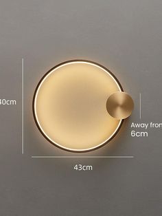 an image of a round light fixture with measurements for the size and width in front of it