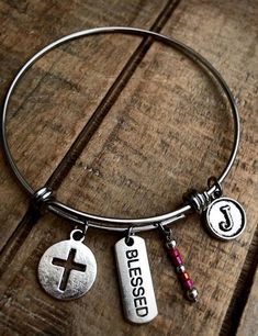 "Stainless steel adjustable Blessed bracelet can be made with a Hammered Rectangle charm or Circle Cut Out charm and your choice of a letter initial charm. These come in either 2.6\" large, 2.4\" average, or 2.0\" (child size). Stainless steel will not tarnish and will be durable for years to come. If you would like a different color of bead than in the pictures, please send a note with your purchase. **Please add a note with your choice of letter charm** INSTRUCTIONS: Please send the informatio Adjustable Stainless Steel Beaded Bangle Bracelets, Adjustable Stainless Steel Beaded Bangle, Adjustable Stainless Steel Beaded Bracelet, Adjustable Stainless Steel Charm Bracelet For Friendship, Adjustable Stainless Steel Friendship Charm Bracelet, Adjustable Friendship Name Bracelet With Charms, Adjustable Charm Bracelets, Adjustable Metal Name Bracelet With Charms, Adjustable Charms Bangle For Gift