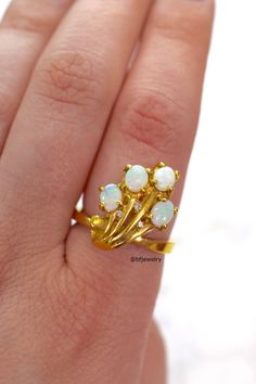 Metal: 14kt Yellow Gold Stone: Opal And Diamond Shape: Round And Oval Approximate Opal Weight: .64 ctw Approximate Diamond Weight: .06 ctw Length Of Center Of Ring: 18.67 mm Weight Of Ring Including Stones: 6.40 grams Ring Size: 7 1/2 Sizing: Please state ring size in the personalization box. Age: New item from the late 90s. It has been in our inventory since the late 1990s and has never been worn. Classic White Multi-stone Cluster Ring, White Cluster Ring Stamped 14k, Gift Yellow Gold Multi-stone Opal Ring, Gift Multi-stone Opal Ring In Yellow Gold, Luxury Yellow Gold Opal Ring With Brilliant Cut, Classic Gold Opal Ring With 17 Jewels, Fine Jewelry Opal Ring With Multi-stone For Anniversary, 14k Yellow Gold Multi-stone Opal Ring, Yellow Gold 14k Multi-stone Opal Ring