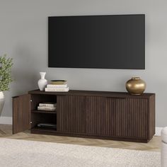 a large flat screen tv mounted to the side of a wooden entertainment center in a living room