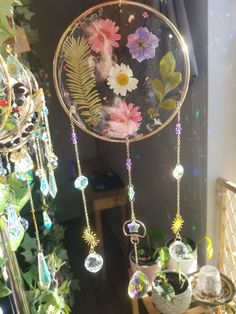 a mirror with flowers hanging from it's sides in front of a planter