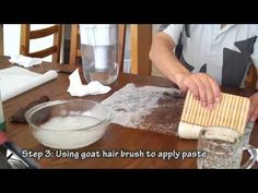 a man making pizza dough on top of a wooden table