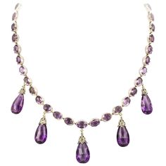 A late Victorian amethyst necklace and earrings, the necklace consisting of thirty-nine oval faceted amethyst, all set in cut-down collets, suspending five pear-shaped briolette-cut amethyst drops each with diamond-set cap of foliate design, all mounted in silver to yellow gold back, accompanied by matching drop earrings with gold wire fittings, circa 1880, the necklace measuring approximately 42 x 3.8cm, the earrings measuring approximately 3.7 x 1.3cm, gross weight 54 grams. Unmarked tested as Antique Amethyst Jewelry, Purple Stone Necklace, Princess Jewelry, Beaded Bracelets Tutorial, Purple Jewelry, Purple Necklace, Amethyst Gold, Amethyst Jewelry, Fabulous Jewelry