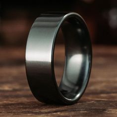 a black ring sitting on top of a wooden table