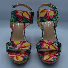 A Floral-Patterned, Open-Toe Wedge Sandal With An Ankle Strap And Adjustable Buckle. The Shoe Features A Multicolored Fabric Upper With A Tropical Flower And Hawaiian Theme. New In Box. Casual Wedge Sandals With Floral Print, Multicolor High Heel Fabric Sandals, Casual Floral Print Wedge Heel Sandals, Multicolor Fabric Sandals With Round Toe, Beach Sandals With Floral Print And Closed Toe, Summer Floral Print Wedge Sandals, Spring Beach Floral Print Wedge Sandals, Closed Toe Fabric Wedge Sandals For Vacation, Fabric Wedge Sandals For Summer