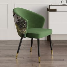 a green chair sitting on top of a hard wood floor next to a white wall