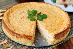 a cheesecake on a plate with a slice cut out and ready to be eaten