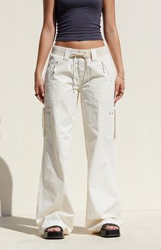 Step out in style with the Bone Low Rise Baggy Flare Pants from PacSun. Designed for both comfort and utility, these pants feature a low-rise fit, ribbed drawstring waistband, and zipper side pockets. Complete with cargo strap pockets on the legs and flared leg openings, they offer a trendy, relaxed baggy look for any occasion.