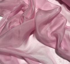 the pink fabric is laying on top of each other