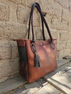 Made from amazing Cognac, burgundy and chocolate brown (US tanned), full grain leathers. :) It is: ~16" across ( tapering to ~12" at bottom) X 11" tall X 4.5" wide Straps: Hand dyed veg tanned leather / ~13" drop One inner pocket: 7" X 6" Made with love! Brown Oiled Leather Bag With Leather Handles, Burgundy Leather Satchel With Leather Handles, Brown Oiled Leather Rectangular Bag, Brown Rectangular Oiled Leather Bag, Brown Saddle Bags With Leather Backing, Brown Saddle Satchel In Soft Leather, Brown Oiled Leather Shoulder Satchel, Leather Burgundy Satchel Tote, Brown Leather Satchel With Double Handle