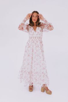 Get ready to turn heads with the Romance In The Air Dress! This off-white dress boasts a stunning floral print and a flattering V neckline. The smocking around the waist and sleeve cuffs creates a perfect fit, while the long sheer sleeves add an elegant touch. With a maxi length and a tier on the skirt, this dress is sure to make you feel like a romantic dream! Details Off white dress with floral print V neckline Smocking around waist and sleeve cuffs Fully lined Long, sheer sleeves Maxi length White Floral Print Long Sleeve Maxi Dress, White Floral Print V-neck Maxi Dress, Non-stretch White Floral Print Dress, White Floral Print Maternity Maxi Dress, Nursing Friendly Tops, Nursing Friendly Dress, Bohemian Off-white Ruffled Maxi Dress, Plus Jumpsuit, Off White Dresses