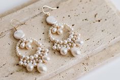 A beautiful pair of bridal earrings made with high quality freshwater pearls in an array of shapes and sizes for a stunning natural look.  The earrings measure approximately 2.5" in length and 1" in width. Please message if you require alternative sizes. The earrings are available in gold, rose gold, or silver plate (all hooks are 14k gold filled, 14k rose gold filled or sterling silver to be safer for your ears). Alternatively you can opt for a more luxurious finish with all metal parts in 14k Dangle Pearl Drop Earrings In Mother Of Pearl, Dangle Mother Of Pearl Drop Earrings, Pearl Teardrop Chandelier Earrings For Pierced Ears, Pearl White Dangle Bridal Earrings With Pearl Pendant, Pearl Drop Earrings In Mother Of Pearl, Pearl White Chandelier Drop Earrings, Dangle Pearl Drop Earrings, Teardrop Pearl Drop Chandelier Earrings, Teardrop Chandelier Earrings With Pearl Drop