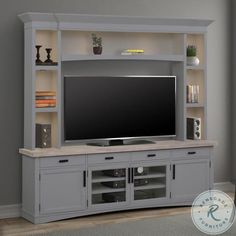 a large entertainment center with a flat screen tv on it's stand and shelves