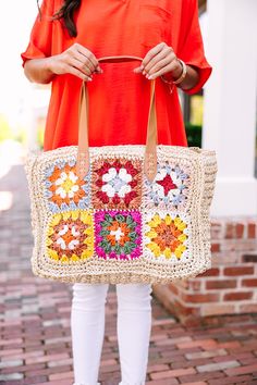 Turn heads with this stunning tote, featuring a captivating crocheted floral design that's sure to make a statement. Its unique craftsmanship offers a delightful blend of style and functionality, perfect for everything from beach outings to city shopping trips. White Square Crochet Bag For Beach, White Square Crochet Beach Bag, White Square Crochet Bag For Vacation, Spring Vacation Tote Crochet Bag, Beachy Natural Crochet Bag For Spring, Multicolor Straw Crochet Bag For Vacation, Beige Granny Square Bag For Beach, Cream Rectangular Crochet Beach Bag, Beige Granny Square Bags For Vacation