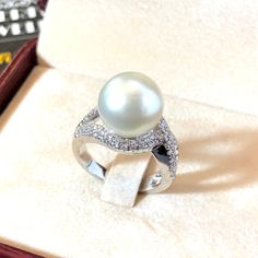 Genuine SOUTH SEA PEARL, absolutely natural color and luster, 12.0 mm in size, surrounded by 72 pieces of hand-set F/VS superb quality diamonds, weighting at 0.63 carats. Set in handcrafted, one of a kind 18K solid white gold ring, weighting at 9.0 grams. The pearl is naturally cultured from South Australia Sea, its luster is extra fine, AA+ grade with 90% clean surface. Color is pure white. The shape is round. SUGGESTED RETAIL PRICE: $5,850 The ring is hand crafted to a high standard and is NOT Luxury White Pear-shaped Diamond Ring, White Pearl Platinum Ring With Diamond Accents, White Pearl Ring With Diamond Accents In Platinum, Luxury White Pear Shaped Rings, Formal White Pear-shaped Diamond Ring, Exquisite White Platinum Pearl Ring, Exquisite White Pearl Platinum Ring, White Pear Shaped Rings With Diamond Accents, White Pear-shaped Rings With Diamond Accents