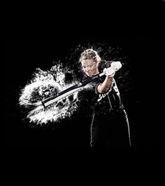 a man holding a baseball bat in his right hand and hitting the ball with it