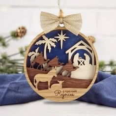 a wooden ornament with nativity scene on it