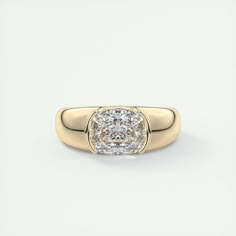 a yellow gold ring with a cushion cut diamond in the center, on a white background