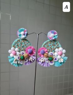 Handmade Statement Floral Pink-Purple - Blue Hoop Earrings. These stunningly beautiful, purely handmade and handcrafted,intricate earrings are made using raffia, handmade flowers, fabric pompoms, glass beads, and a lot more. The earrings have unique intricate workmanship and undoubtedly beautiful. The earrings are ideal for day parties or just wear them as you want.. The earrings measure approx. 3.20" long and 2.60" wide. Available in two color options: A and B At Carnation jewellery, each piece is artisan handcrafted with love and care and shipped from India.  * SHIPPING - Please refer to the "announcement" page of the store. * Please be noted all kind of taxes, custom duties, VAT etc will be borne by the buyer as I am not responsible for the same. * For queries, please reach out to me an Bohemian Spring Hoop Earrings For Party, Bohemian Dangle Hoop Earrings For Spring, Handmade Earrings For Spring Party, Handmade Dangle Flower Earrings For Spring, Handmade Multicolor Flower Earrings For Spring, Handmade Flower Earrings For Spring Party, Multicolor Bohemian Hoop Earrings For Spring, Bohemian Flower Earrings For Vacation, Blue Hoop Earrings For Spring