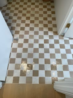 a kitchen floor with brown and white checkered tiles