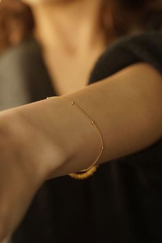 Introducing the Satellite Bracelet--a delicate and enchanting piece that gracefully adorns your wrist with understated elegance. Embrace the beauty of simplicity with this dainty chain bracelet that exudes charm and sophistication. 14k Gold Filled Bracelet Width - 1.2mm Extender - 1 inch If you would like a custom length, please don't hesitate to ask. We are more than happy to make one for you. All items come packaged in a gift box ready to give as a gift or keep for yourself. Gold-filled jewellery is a more affordable alternative to solid gold jewellery while still offering a similar appearance and durability. The thick layer of gold provides a long-lasting and tarnish-resistant finish so you can have pieces that will last. Our boxes are ECO friendly and FSC certified. FSC stands for Fore Delicate Adjustable Charm Bracelet, Delicate Chain Link Bracelet For Gift, Delicate Chain Bracelet With Jubilee Details As Gift, Delicate Jubilee Chain Bracelet As Gift, Delicate Jubilee Chain Bracelet For Gifts, Adjustable Gold Bracelet With Beaded Chain For Gift, Adjustable Beaded Gold Bracelet Gift, Adjustable Beaded Gold Bracelet As Gift, Elegant Rosary Bracelet With Tiny Beads As Gift