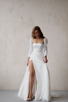 a woman in a white dress with a slit