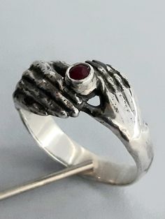 Ring with  ruby sterling silver  925, weight 5,5 gr, size 9,2 gr. Female and Male hand hold a stone.Made of sterling silver, marked 925 and my name stamp, registered in Estonian Assay office. Will be shipped in a pearl white jewellery box. Gift White Gold Hand Cast Ring, Ruby Rings Stamped 925 For Anniversary, Unique Hallmarked Ruby Promise Ring, Anniversary Ruby Rings Stamped 925, Unique Silver Ruby Birthstone Ring, Spiritual Hand Cast Rings For Anniversary, Sterling Silver Anniversary Ring, Sterling Silver Anniversary Ruby Ring Stamped 925, Silver Sterling Ruby Ring For Wedding