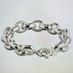 a close up of a silver chain bracelet on a white background with an empty space for text