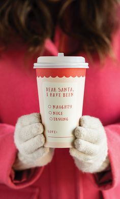 a woman holding up a coffee cup with the words dear santa i have been on it