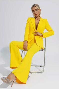 The first choice for urban women's professional wear is our new product Sylvie Yellow Long Sleeve Blazer Set. The upper body of the suit is a long-sleeved V-neck blazer, with a row of round buttons on the cuffs. The lower body is slightly slit bell-bottom pants with an invisible zipper design. The cloth buttons with well-cut and graceful curves. Whether for everyday wear or attending a party, this set is a standout!  Top Length: Approx 68cm Pants Length: Approx 104cm Materials: Polyester Gentle Yellow Women Suit, Monochromatic Yellow Outfit, Suit Ideas Women, Yellow Photoshoot, Bill Design, Cloth Buttons, Yellow Suit, Yellow Long Sleeve, Church Suits