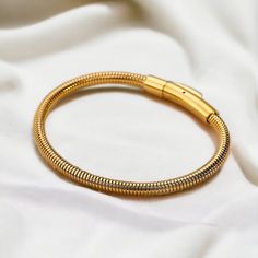 ✨ Gold Bangle Bracelet ✨ Introducing our exquisite Gold Bangle Bracelet, crafted for timeless elegance and versatility. Ideal as a gift for her, bridesmaids, weddings, or birthdays, this minimalist accessory enhances any outfit with its sophisticated design. Elevate your style with this must-have piece of personalized jewelry. ✨FREE DELIVERY✨  ✨What's Included: 1x 18k Gold styled Stainless Steel Gold Bangle Bracelet (6cm x 0.4cm) ✨M A T E R I A L✨ Stainless Steel  ✨S I Z E✨ 6cm x 0.4cm  10.0g *- Adjustable Chain Bangle As A Gift, Elegant Snake Chain Charm Bracelet For Gift, Flexible Metal Chain Bracelet For Gift, Flexible Metal Chain Bracelet As Gift, Flexible Metal Chain Bracelet Gift, Adjustable Gold Bracelets For Bridesmaids, Adjustable Gold Bracelet For Bridesmaid Gift, Flexible Metal Jewelry As A Gift, Adjustable Jubilee Snake Chain Bracelet