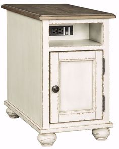 an old white cabinet with a clock on top