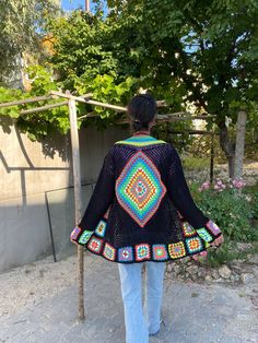 in stock! Granny square black boho style patchwork cardigan is combined with inspiration from the rainbow. :) The yarn used in the cardigan is cotton. It will be a unique gift to have a wonderful product for your loved ones for their birthdays and special occasions! Be the sparkle of your festivals and parties! Cardigan Sizes Width 105 cm / 41.3 inch Height 70 cm / 27.5 inches Model Size: 178 cm / 5 Feet 10.79 Inches / 63 kg - 138 lb. washing information It can be washed in the hand wash program Granny Square Long Sleeve Festival Cardigan, Granny Square Long Sleeve Cardigan For Festivals, Long Sleeve Granny Square Cardigan For Festival, Festival Long Sleeve Granny Square Cardigan, Bohemian Multicolor Cardigan For Festivals, Bohemian Multicolor Festival Cardigan, Bohemian Black Patchwork Outerwear, Black Bohemian Patchwork Outerwear, Bohemian Black Outerwear With Patchwork