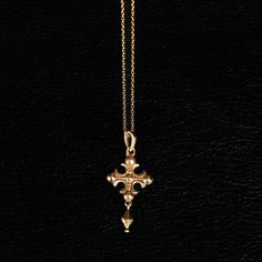 A fusion of medieval aesthetics and tragic beauty, this piece reflects faith's role as a guide through the material world. A tool for divine connection, it embodies reverence while transcending the ordinary. The intricately designed cross, adorned with fleur-shaped extremities, evokes both elegance and the timeless power of protective talismans.  Design: by NOIR KĀLA Material: Brass Size: 1.8 cm x 3 cm Weight: 2 g Spiritual Brass Crucifix Jewelry, Gothic Gold Cross Pendant Jewelry, Bronze Cross Spiritual Jewelry, Bronze Spiritual Cross Jewelry, Medieval Cross Pendant Necklace Gift, Spiritual Bronze Cross Jewelry, Gothic Gold Pendant Necklace, Medieval Gold Jewelry Gift, Medieval Style Gold Jewelry For Gift