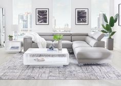 a modern living room with white furniture and large windows overlooking the cityscape in the background